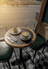 Cappuccino and delicious whipped creme dessert on wooden table in cafe. Mockup for cafe or restaurant with copy space.