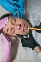 Attractive man receiving the skin treatment procedures. Beauty Face