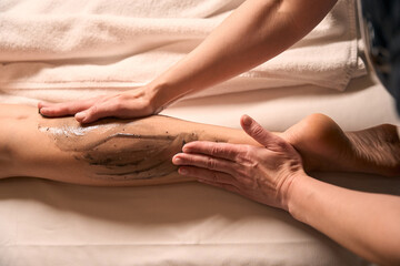 Skilled masseuse carrying out anti-cellulite massage session - obrazy, fototapety, plakaty