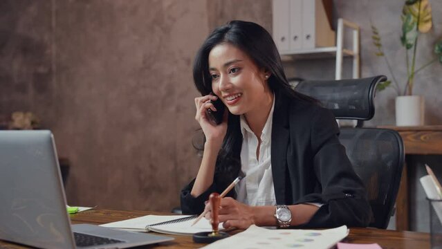 Asian business woman, sale manager, female entrepreneur is using a mobile phone to contact, making a deal, discussion of project or ordering product for company. Concept of client and customer service