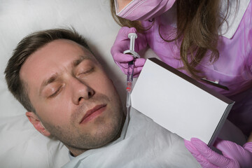 An Anonymous Female Beautician Giving Male Patient Botox Injection In Forehead. Anti Aging Treatment: Side view of mature man receiving botulinum toxin injection at medical clinic.