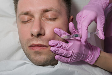 Man during surgery filling facial wrinkles