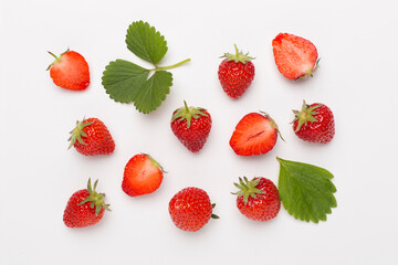 Strawberries with leaves on white background, top view