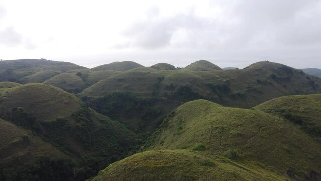 Aerial view, big rolling Teletubbies Hills in Nusa Penida Island, Bali - Indonesia.
Fertile tropical grassy Farmland Hills and a tourist attraction for its unique geologic cone shape