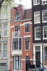 Fototapeta na wymiar Amsterdam Canal Red Brick House Facade, Netherlands