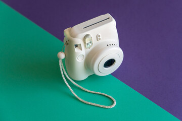 Traditional plastic photo camera on a colored background. Isometric view. Colorful paper bevels.