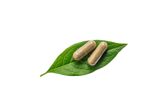 Herb supplement capsules on green leaf isolate on white background. Selective focus.