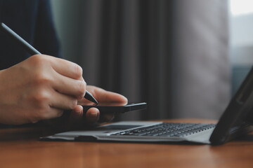 Fototapeta premium Asian Businesswoman Using laptop computer and working at office with calculator document on desk, doing planning analyzing the financial report, business plan investment, finance analysis concept.