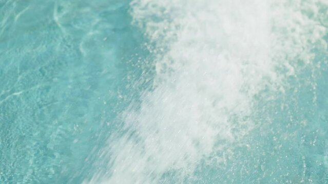 Big bubbles in warm water in a jacuzzi pool in mountain resort luxury hotel slow motion. Hydroterrapy. Strong water pressure in the spa salon. The texture of boiling water. Relax. Tourism. Family