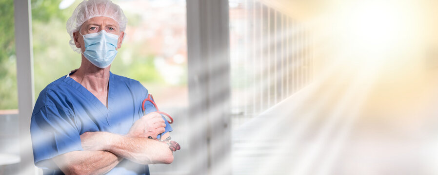 Portrait of surgeon with arms crossed wearing a face mask; multiple exposure