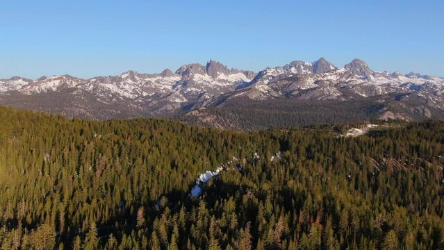 Aerial Cinematic drone early sunrise Spring lack of snow Mammoth Mountain California Sierra Nevadas mountain landscape forward movement