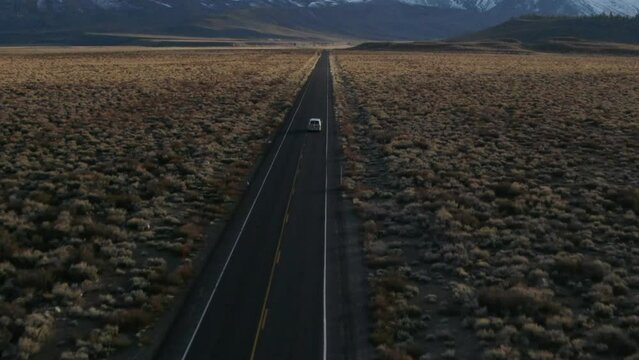 Aerial Cinematic drone Mammoth Lakes California i395 Sierra Nevada Mountains Van driving by hilltop hot spring late after sunset stunning panning forward movement
