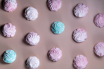 Multicolored, pink, blue marshmallows and meringues close-up, flat lay, pattern