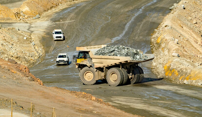Loaded dump truck driving in Cerro colorado, the largest active open pit mine in Europa producing...