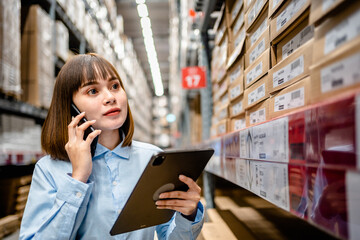 Warehouse Worker using smartphone and digital tablets to check the stock inventory in large warehouses, a Smart warehouse management system, supply chain and logistic network technology concept