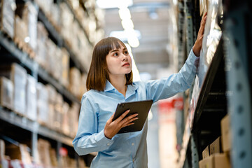 Women warehouse worker using digital tablets to check the stock inventory on shelves in large warehouses, a Smart warehouse management system, supply chain and logistic network technology concept