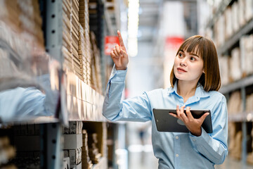Women warehouse worker using digital tablets to check the stock inventory on shelves in large warehouses, a Smart warehouse management system, supply chain and logistic network technology concept