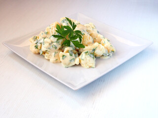 Potatoes alioli (aioli), a traditional Spanish tapas, served with parsley