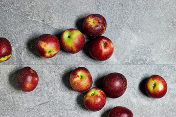 Fresh sweet ripe peaches on gray grunge background