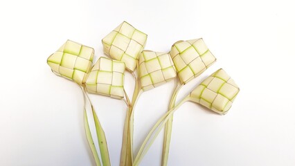 Ketupat or rice dumpling is tradition food during celebration eid fitri, eid mubarak, and eid adha. Ketupat is natural rice made from coconut leaves for cooking isolated on white background