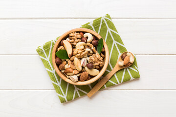 mixed nuts in bowl. Mix of various nuts on colored background. pistachios, cashews, walnuts, hazelnuts, peanuts and brazil nuts