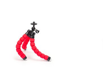 Mini tripod with flexible red legs and mobile phone holder.