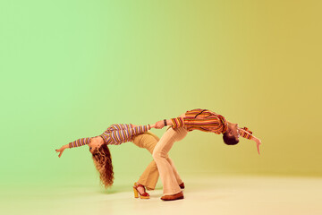 Emotional expressive young man and pretty woman in vintage style outfits dancing retro dance...