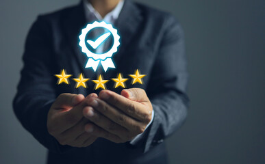 A businessman holding up a quality guarantee mark and five stars signifies certification for iso...