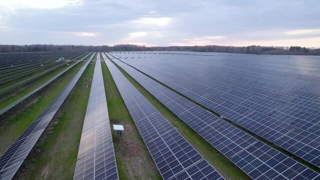 Drone flight over long rows of solar panels, Polish solar power plant