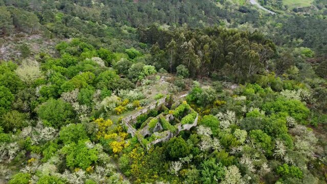 Aeiral drone shot of ruins from the Monastery of Santa Comba de Naves in Ourense, Spain