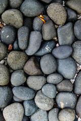 dark aged rocks with depth, round rocks. coarse, gray stone or rocks texture for background. natural theme