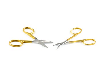 Gold silver metal nail scissors. Small metal manicure scissors isolated on white background.