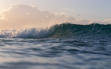 Beautiful wave breaking on the beach shore.