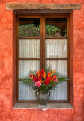 Fototapeta na wymiar Flower arrangement in a window in Antigua, Guatemala
