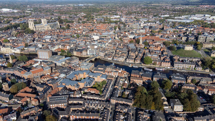 Obraz premium Aerial photo of the town of York located in North East England and founded by the ancient Romans, showing the York Minster Historical Cathedral in the main town centre along the river side.