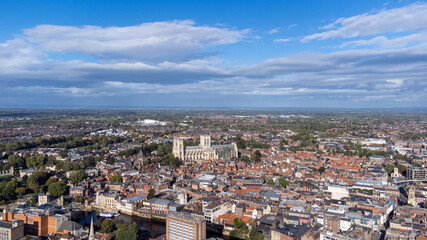 Fototapeta na wymiar Aerial photo of the town of York located in North East England and founded by the ancient Romans, showing the York Minster Historical Cathedral in the main town centre along the river side.