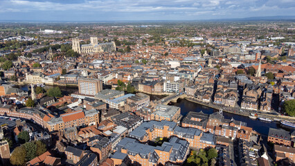 Obraz premium Aerial photo of the town of York located in North East England and founded by the ancient Romans, showing the York Minster Historical Cathedral in the main town centre along the river side.