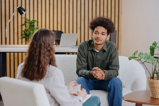 young man in consultation with psychologist is taking care of mental health. Psychotherapy for treatment of disorders and depression, insomnia. African American guy tells doctor about his problems