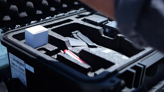 Drone pilot putting drone in a box and closing it