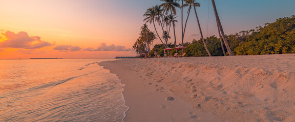 Beautiful panoramic sunset tropical paradise beach. Tranquil summer vacation or holiday landscape. Tropical sunset beach seaside palm calm sea panorama exotic nature view inspirational seascape scenic - obrazy, fototapety, plakaty