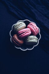 Macaroons on dark background, colorful french cookies macaroons
