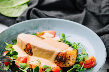 Grilled salmon fillet with spinach and creamy sauce