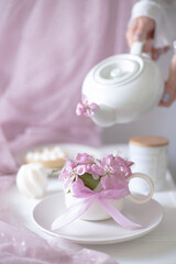 A cup of aromatic coffee and flowers