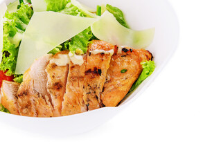 Delicious fresh Caesar salad in bowl on white