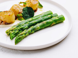 Freshly sauteed scallops with green asparagus