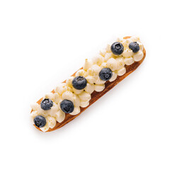 Eclair with vanilla cream and blueberries