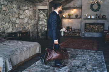 Elegant businessman leaving home with bag