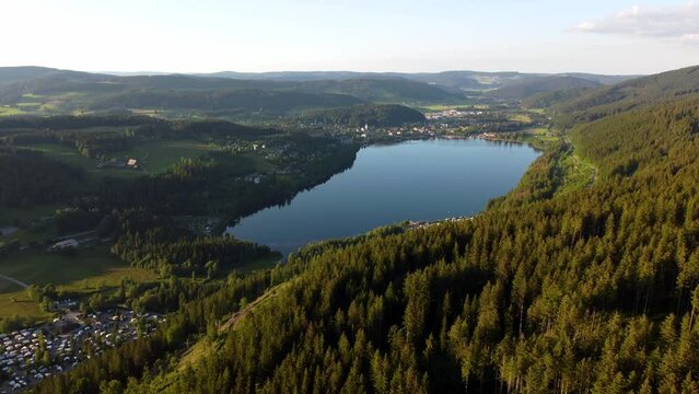 Aerial drone footage of flight along the scenic Lake Titisee in the Black Forest in Southern Germany at sunset