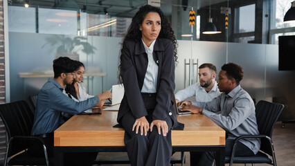 Worried sad upset leader woman worker businesswoman sitting on table in conference room thinking...