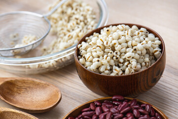 Hot Boiled Job’s Tears millet seed from boiler. White boiled Job’s Tears is highly nutritious cereal healthy fresh organic in salad dish.